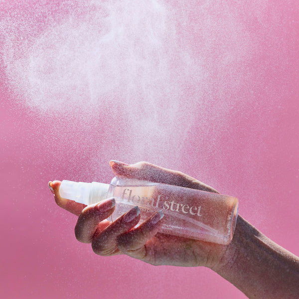 Wonderland Peony Perfume Mist 125ml bottle in hand with pink background | Floral Street